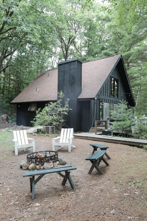 Small House Black Exterior, Dark Grey Bungalow Exterior, Modern Cabin In The Woods Exterior, Black Cabin In The Woods, Black Exterior Cabin, Black Exterior Cottage, Cabin On The River, Black Cabin Exterior, Black Cottage Exterior