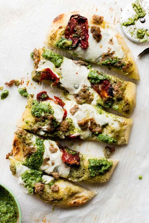 Spicy sausage, garlic pesto, sun-dried tomatoes, and mozzarella on homemade flatbread dough! Easy and quick homemade flatbread recipe on sallysbakingaddiction.com Homemade Flatbread Pizza Dough, Pesto Flatbread Recipes, Flatbread Ideas, Homemade Flatbread Pizza, Homemade Flatbread Recipes, Sausage Flatbread, Pita Wraps, Pesto Flatbread, Flatbread Dough