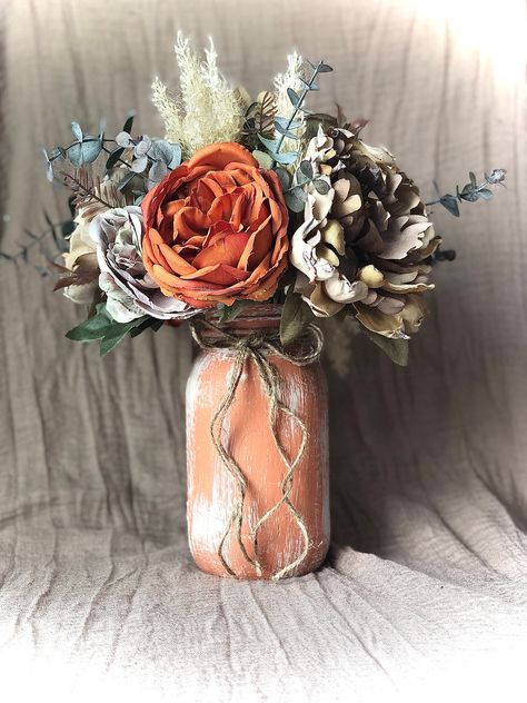 Thank you for your interest in my small business :)  I have four different floral arrangements available. The quart mason jar measures 7 inches high and 3 3/4 inches wide/diameter.  This beautiful mason jar is the perfect addition to your rustic home decor or for a rustic wedding/baby shower as well. Arrangement #1- Taupe peony and pampas grass measures 10 inches wide and 13 inches tall. Arrangement #2- Ruscus bouquet measures 10 inches wide and 11 inches tall. Arrangement #3-Sunflower mix measu Burnt Orange Wedding Centerpieces, Ruscus Bouquet, Pampas Grass Centerpieces, Wedding Decor Pampas, Grass Centerpieces, Pampas Grass Centerpiece, Terracotta Wedding Decor, Orange Wedding Centerpieces, Fall Bridal Shower Decorations