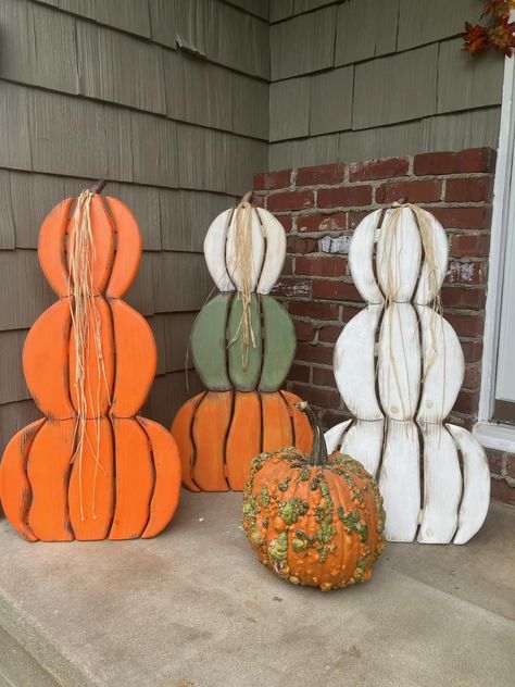 Ready for Fall?  These stacked pumpkins are great for your outdoor porch or indoor decor.  Made from solid 3/4" pine wood, glued, nailed together, and stained by hand.  They are distressed for a vintage look or solid finish and then polyurethane to protect from the elements.  They are designed with a folding easel leg for standing and easy storage.  They are available in a solid stack of all orange or all white or all green or all black, or you can order the three color stack white, green and orange. If you would like your pumpkin stack to be custom colors, please order the multi colored stack. Once I receive the order, I will contact you for your color combinations and I will make it your way.   The colors that I use are orange, white, green, black, yellow, blue and pink.  Start with the Pumpkin Porch, Fall Wood Crafts, Porch Pumpkins, Pallet Patio Furniture, Halloween Wood Crafts, Wood Snowman, Pallet Patio, Wooden Snowman, Pumpkin Autumn