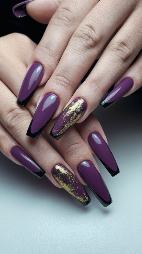 Transform your manicure into a royal affair with these gorgeous purple acrylic nails adorned with shimmering gold and sleek black tips! The rich purple hue catches the light beautifully, while the touch of gold shimmer adds a luxe finish. Perfect for special occasions or whenever you want to feel glamorous, these nails are a stunning blend of sophistication and creativity. #nailsdesign #acrylicnails #septembernails #autumnnails #fallnails Purple And Gold Nails Acrylic, Dark Purple And Gold Nails, Purple Shimmer Nails, Gold And Purple Nails, Purple And Gold Nails, Gold Coffin Nails, Black Acrylic Nail Designs, Dark Purple Nails, A Royal Affair