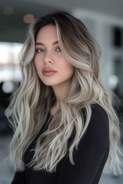 Young woman with long, wavy blonde hair and a black top, looking at the camera. Blonde Brown Ash Hair, Platinum Blonde Balayage Ombre Ash Brown Hair Color Ideas, Brown Hair With White Balayage, Brown Hair Ash Blonde Balayage, Ashy Highlights On Light Brown Hair, Ash Brown Hair Blonde Highlights, Ashy Blonde And Brown Hair, Light Blonde Balayage On Dark Hair, Ashy Blonde Balayage On Brown Hair