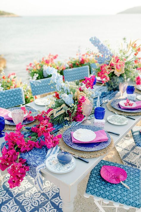 This Greece sailboat elopement is bursting with vibrant colors, pattern play and climbing bougainvillea in the most epic boat party we have seen since the Dancing Queen scene in Mammia Mia. If you love custom heraldry, whimsical motifs or modern romantic table settings, head over to Ruffled Blog to see this destination wedding along the Aegean Sea in all its glory! #sailboatwedding #greeceelopement #bougainvilleamood Greece Themed Engagement Party, Wedding Venues Preppy, Santorini Greece Theme Party, Santorini Table Setting, Mama Mia Table Decorations, Mama Mia Themed Picnic, Mamma Mia Style Wedding, Mamma Mia Dinner Table, Mama Mia Table Settings