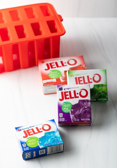 How to Make Jello Popsicles - Hooray for no more messy melted popsicles! This classic recipe uses everyone's favorite boxed gelatin for no-drip ice pops that are flavorful and fun. | A Spicy Perspective Homemade Jello Popsicles, Popsicle Recipes With Jello, No Drip Jello Popsicles, How To Make Ice Pops, Ice Cream Jello Recipes, Jello Popsicle Recipes, Things To Make With Jello, Sugar Free Popsicle Recipes, How To Make Popsicles