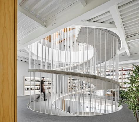 Constructed with formwork on-site, the 4-inch-thick ramp is shaped like an orange peel. In northern Portugal, a sculptural ramp joins two buildings�—and two companies—into a cohesive, flexible, future-proof whole by Paulo Merlini Architects. #interiordesign #architecture Spiral Architecture, Ramps Architecture, Ramp Design, Concrete Walkway, Studios Architecture, Spiral Stairs, Ground Floor Plan, Architecture Office, Spiral Staircase