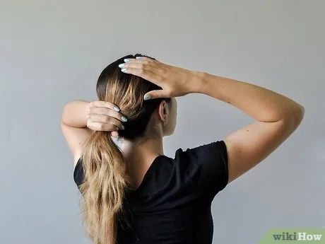 Brush your hair into ponytail position. Use a flat brush to sweep the two front sections of hair toward the back. Use your hand and your brush to combine them with the middle section of hair, bringing them together as if you were creating a ponytail. Hold your hair in this position, but do not secure it with a hair tie. Simple Hairstyle, Flat Brush, French Knot, Head Hair, Hair Tie, Hair Ties, Easy Hairstyles, Knot, Sleek