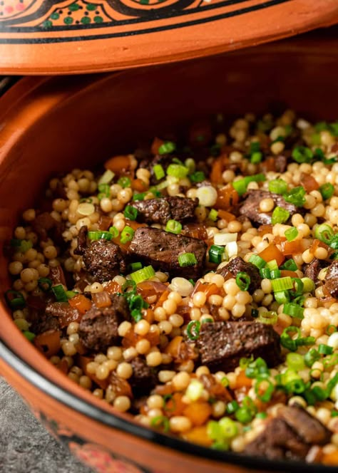 This lamb and pearl couscous recipe is a mouthwatering combination of marinated lamb, sauteed veggies, and fluffy pearl couscous. Lamb And Couscous, Lamb And Couscous Recipes, Lamb Couscous Recipes, Lebanese Couscous Recipes, Pearl Cuscus Recipes, Roasted Couscous, Giant Couscous Recipes, Pearl Couscous Recipes Dinner, Mediterranean Lamb Recipes