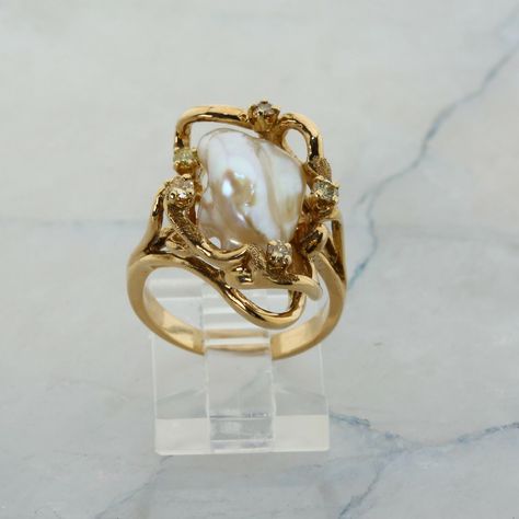 14K Yellow Gold Pearl and Diamond Ring, interesting asymmetrical design, Ring size 6.5, 8.7 grams Stock # R00070 This listing contains photographs of the actual item you will receive.  Our items are in excellent condition with little or no signs of wear and many are one of a kind pre-owned estate finds.   Please look closely at the pictures in this listing as they are part of the product description. Please read the description, as any imperfections or condition comments will be included.  We do our best to accurately describe the condition of each piece and encourage you to ask questions prior to purchase.    We are happy to address any questions you may have.  Please contact us.  Our Store has many other items for sale.  We specialize in fine & designer jewelry, watches & more.    Coloni Pearls Rings Design, Vintage Stone Wedding Rings, 3 Tier Wedding Ring, Pearl And Gold Jewelry Aesthetic, Diamond Gemstone Ring, Vintage Italian Engagement Rings, Antique Engagement Rings Vintage 1920s Gold, Unquie Wedding Rings, Taurus Engagement Ring