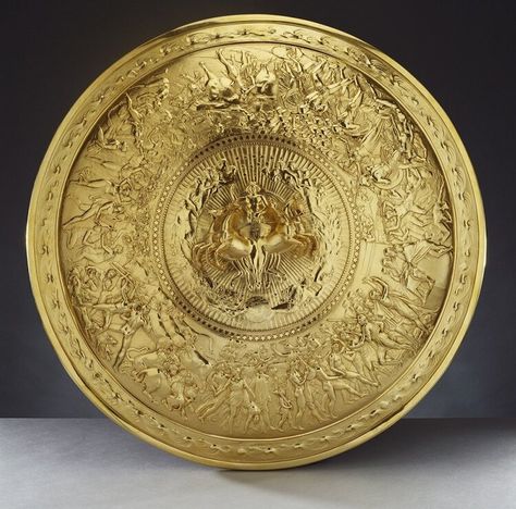 An interpretation of the Shield of Achilles design described in Book 18 of the Iliad, by PHILIP RUNDELL (1746-1827) A silver-gilt convex shield with a central medallion cast in high relief showing Apollo in a quadriga, surrounded by stars and female figures representing the constellations. The broad border is cast in low relief with scenes of human life (a wedding and banquet, siege, ambush and engagement, harvest, judicial appeal, vintage, oxherds defending their beasts and a Cretan dance), w Shield Of Achilles, Royal Collection Trust, Greek And Roman Mythology, The Royal Collection, Roman Mythology, The Shield, High Relief, Ancient Greece, Clone Wars