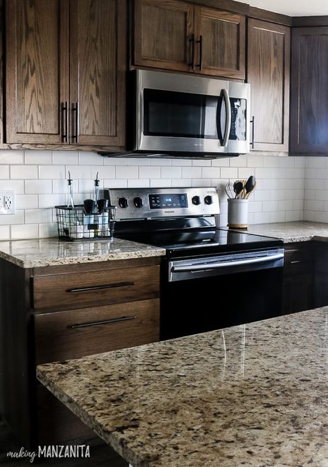 Loving this DIY tutorial for tile backsplash in this modern farmhouse kitchen! So many great ideas! The ceramic white subway tile really brightens up the kitchen that has dark cabinets. Learn how to install your own tile backsplash! #DIY #kitchen #tile #backsplash #kitchens Dark Cabinets With Backsplash, Dark Kitchen Cabinets Dark Countertops, Backsplash Ideas With Dark Countertops, Kitchen Backsplash Dark Wood Cabinets, Ornamental Granite Countertops, Dark Brown Kitchen Cabinets Farmhouse, Backsplash For Brown Cabinets, Backsplash With Dark Countertops, Backsplash Kitchen Brown Cabinets