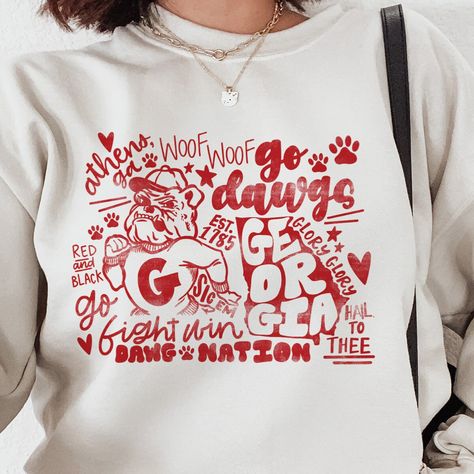 Embrace school spirit with our Classic Collegiate Georgia Bulldog Sweatshirt! Designed for ultimate comfort and long-lasting wear, this unisex crew neck is a must-have for any proud fan. Available in a wide range of colors and sizes to fit all, you can find the perfect match for your personal style on our website. Each piece boasts a vibrant, playful bulldog design, making it a standout addition to your wardrobe or a memorable gift. Proudly made by our dedicated small business, this sweatshirt is not just a piece of clothing, it's a statement of support for local craftsmanship and quality. Shop now to wear your pride on your sleeve! Please choose between long sleeve t shirt or sweatshirt.  **Product Details - Unisex, crewneck sweatshirt - 50/50 cotton and polyester - For best fit and color Georgia Bulldog Shirts, Bulldogs Sweatshirt, Sparkle Georgia Bulldog Shirt, Georgia Bulldog Shirts Women, Georgia Bulldogs Sweatshirt, Georgia Bulldogs Shirt, Bulldog Sweatshirt, Uga Football, Bulldog Shirt