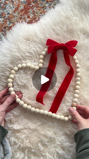 Annelise on Instagram: "🎀❤️ DIY Dollar Tree Bead Heart Wreath ❤️🎀 This is the easiest DIY wreath you’ll make! What you’ll need: 🔨💕 • Round bead wreath from @dollartree • Pliers • Ribbon for a bow • Wire to tie the bow on How to make it: 🫶🏻 • Use pliers to open the wreath form and remove one bead. Close it clamping the wire tight. • Shape the wreath into a heart. Position the opening on the side to cover it with the bow. • Secure a bow on with floral wire • Hang it up and make your friends believe you spent way more than a few $ to make it. 😉 #diy #dollartree #dollartreediy #dollartreewreath #dollartreevalentines #beadwreath #woodbeads #heart #heartwreath #budgetfriendly #crafts #valentinesdiy #valentinesday" Diy Flower Wreath Wire Frame, Diy Valentines Wreath, Wire Heart Wreath, Heart Wreaths, Bead Wreath, Bead Heart, Easy Diy Wreaths, Wire Wreath Frame, Valentine Ideas