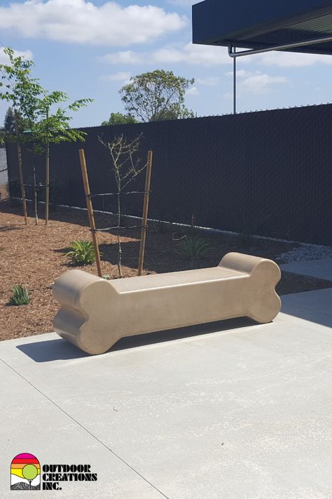 Concrete dog bone bench.  Durable and customizable. Dog Daycare Front Desk, Dog Store Ideas, Dog Cafe Design, Vet Clinic Ideas, Dog Park Design, Dog Boutique Ideas, Dog Event, Veterinary Design, Animal Shelter Design