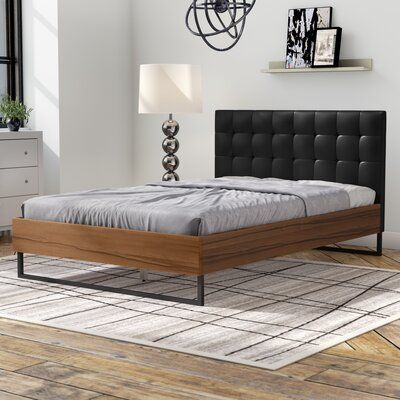 Latitude Run® This Upholstered Platform Bed combines solid wood, metal and upholstery into a modern piece of bedroom furniture. Constructed of solid wood frame and finished in walnut Arcacia veneer, this collection is built to last. The bed frame is designed to be striking and bold, while allowing the wood to float. Featuring angular industrial details, the dark bronze powder coated steel legs help to give structure and form to the piece while the upholstered headboard, overly padded and with gr Platform Bed Headboard, Black Leather Bed, Bed Headboard Wood, Philadelphia Apartment, Walnut Bed Frame, Headboard Wood, Leather Platform Bed, Leather Bed Frame, Colorful Headboard