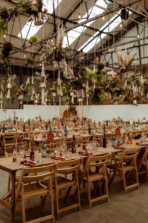 Industrial warehouse wedding venue decorated with DIY hanging plants and macrame and wooden banquet tables and chairs Warehouse Wedding Decorations, Urban Wedding Decor, Industrial Wedding Invitations, Hanging Plant Decor, Industrial Wedding Reception, Flower Cloud, Industrial Wedding Decor, Industrial Wedding Venues, Wedding Gift List