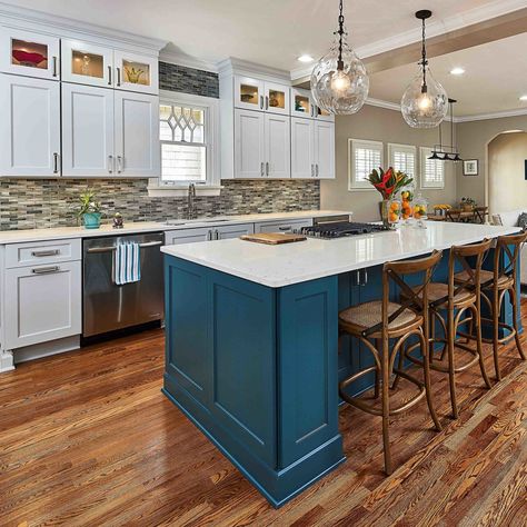 While the appliances remained in their original locations, we removed a U-shaped peninsula in exchange for an island which increased traffic flow and improved the functionality of the kitchen remodel. We extended the cabinets to the ceiling, maximized storage and display space, and inserted a teal island. Islands In Kitchen, Teal Island, Cabinets To The Ceiling, Circle Kitchen, Traditional Fireplace Mantel, Roll Out Shelves, Fireplace Kitchen, Fireplace Update, Glass Tile Backsplash