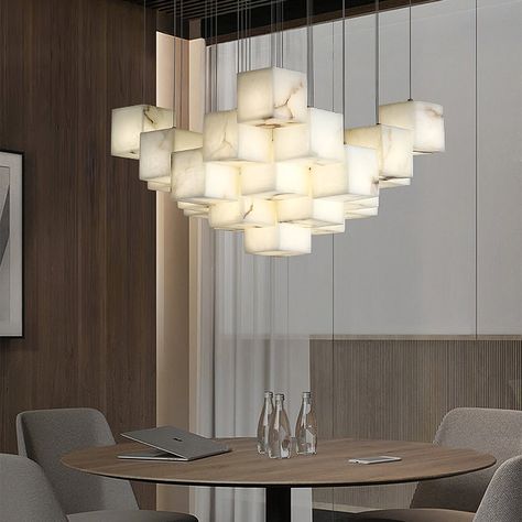 [FEATURE] 
 This Pendant Light is an exquisite and elegant hanging light fixture that features a white color tone. Its uniqueness lies in the design of the lampshade, which is composed of multiple boxes. Each box is meticulously crafted from plaster material, creating an artistic geometric shape that brings a distinctive play of light and shadow to the indoor space Alabaster Box, Chandelier Lighting Modern, Marble Box, White Light Fixture, Box Light, Luxury Marble, Lighting Modern, Structure Design, White Box