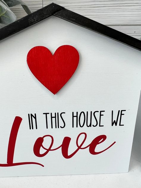 In This House We LOVE.....this home shaped shelf sitter says it all! Sign is finished in white with black "stained look" roof with black vinyl words. Sign is available with red heart and "Love" or light pink heart and "Love". Five little words that say so much, Family, Togetherness....perfect addition to your Valentine's Day Decor! **Listing is for sign only, other items pictured just for styling idea**Dimensions: 5.5 in x 6.25 in H Ready to ship in 2-4 business days. **Tray and accessories not Light Pink Heart, Family Togetherness, February Ideas, I Failed, Love Sign, Sign Lighting, Valentine's Day Decor, Love Signs, Shelf Sitter