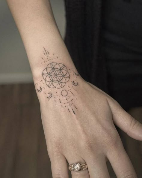 Hand poked flower of life and moon phases tattoo on the Moon Phases Hand Tattoo, The Flower Of Life Tattoo, Sacred Geometry Hand Tattoo, Coldplay Tattoo Symbol, Life Flower Tattoo, Flower Of Life Neck Tattoo, Sacred Geometry Tattoo Women, Seed Of Life Tattoo, Moon Phase Tattoos