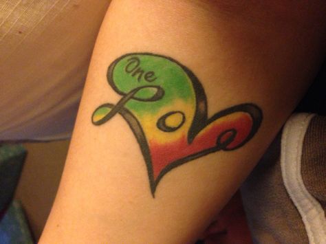 Love tattoo. Heart tattoo. One love. Marley. Bob Marley. Ink. Tattoo. One Love Tattoo Bob Marley, Jamaican Tattoos For Women, Reggae Tattoo Ideas, Bob Marley Tattoo Ideas, Jamaica Tattoo Ideas, Bob Marley Quotes Tattoos, Jamaica Tattoo, Jamaican Tattoos, One Love Tattoo