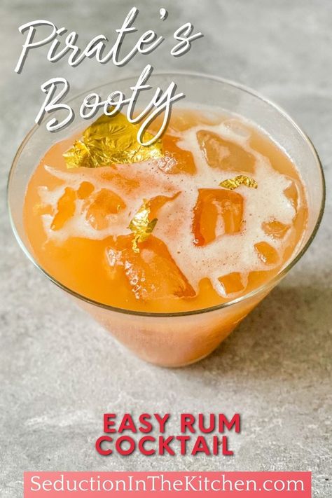 Looking for a fun summer drink? Pirate's Booty is a simple rum drink recipe. This cocktail recipe has edible gold glitter to make it a fun drink recipe to enjoy! | SeductionInTheKitchen.com #rumdrink #rumcocktail Pirate Theme Alcohol Drinks, Gold Rum Cocktail Recipes, Pirate Themed Drinks Rum, Pirate Themed Shots, Pirate Punch Alcohol, Pirate Cocktail Recipes, Rum Alcoholic Drinks, Simple Rum Cocktail Recipes, Spiced Rum Drinks Recipes