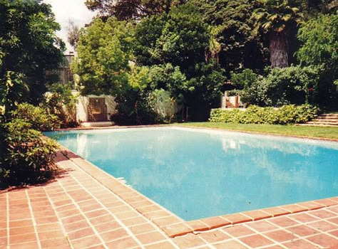 The backyard pool in the back of the Sunset house on Owlwood estates c 1990's. This pool was used by Esther Williams when she owned the house c 1930's. Hagins collection. 60s Swimming Pool, Suburban Backyard Pool, 80's Houses Exterior, 80s Pool Aesthetic, 80s House Exterior Aesthetic, 1920s Pool, 70s Backyard, 80s House Aesthetic, 80s House Exterior