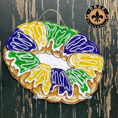 "This King Cake Door Hanger is the perfect addition to your Mardi Gras decorations  It is approximately 15x 24\".   It is a UV print made from my original artwork designed by me It is made of PVC making it extremely durable, waterproof and lightweight.  This would be a great Christmas present for someone on your list being Mardi Gras season is right after Christmas! If wanting to SAVE ON SHIPPING and thinking of ordering 2 pieces from all of my listings, we can put 2 pieces inside one box to low Mardi Gras Wood Signs, Mardi Gras Window Painting, Mardi Gras Door Hangers, Birthday Door Hanger, Mardi Gras Door Hanger, Burlap Door Hangings, King Cake Baby, Mardi Gras Crafts, Mardi Gras King Cake