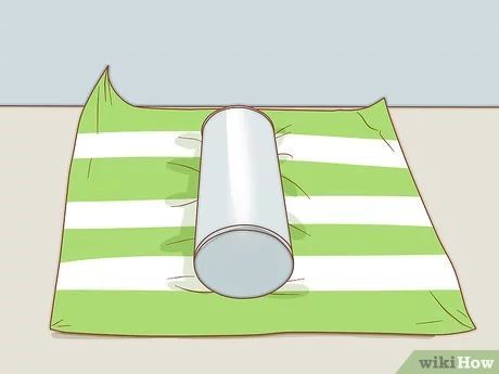 3 Ways to Wrap a Round Gift - wikiHow Packing Round Gifts, How To Wrap Tubular Gifts, Wrapping Round Tins, Gift Wrapping A Rolled Blanket, How To Gift Wrap A Rolled Up Blanket, How To Gift Wrap Cylinders, Round Wrapping Ideas, How To Wrap Tube Presents, Wrapping Cylinder Presents