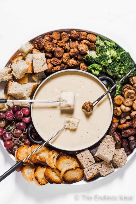 This cheese fondue is creamy, smooth, and by far the best! It's classic melted gruyère cheese flavored with caramelized shallots, apple brandy, and warm spices. It's an easy recipe that's perfect for seasonal gatherings, and it's ready in just 35 minutes! #theendlessmeal #fondue #cheesefondue #gruyerefondue #cheese #gruyere #gruyerecheesefondue #dinner #appetizer Mini Fondue Ideas, Cheese Fondue Board, Christmas Fondue Party Ideas, Vegetarian Fondue, Fondue Cheese Recipe, Fondue Charcuterie Board, Meat Fondue Recipes, Fall Fondue, Fondue Party Ideas