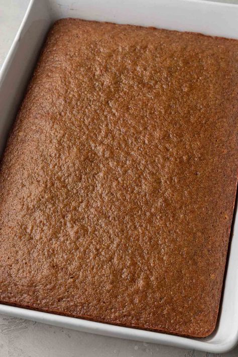 A baked applesauce cake in a white 9x13 baking pan. Applesauce Sheet Cake, Best Applesauce Cake Recipe, Easy Applesauce Cake Recipes, Applesauce Coffee Cake Recipes, Apple Sauce Cake Mix Recipe, Spice Cake With Applesauce, Vegan Applesauce Cake, Applesauce Cake Old Fashioned, Applesauce Cake Easy