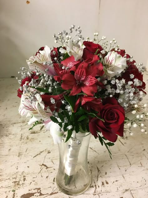 One of our custom bouquets from a wedding. Baby’s breath tinited sliver, a few red roses and white and red alstroemeria with a white wrap around the stems White Bouquet Red Accents, Baby Rose Bouquet, Red And White Wedding Aesthetic, White And Red Wedding Flowers, Prom Bouquet Red Dress, Small Red Bouquet, Red Prom Bouquet Ideas, Red And White Flower Bouquets, Prom Bouquet Red