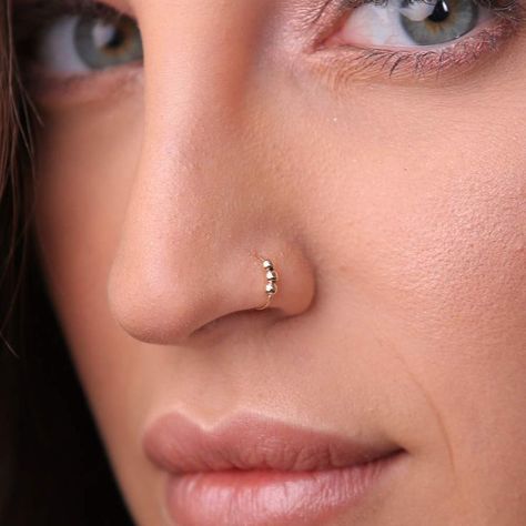 Nose ring piercing is a rising trend among people, and more individuals wish to adorn their nose piercing with quality jewellery. People can purchase quality nose jewellery, including nose pins, rings, studs, labrets, barbells and fishtails according to their taste online. Nose Ring Stud Gold, Nose Pin Indian, Nose Piercing Ring, Nose Ring Jewelry, Nose Piercing Hoop, Beauty Hacks Skincare, Gold Nose Stud, Jewelry Piercing, Nose Piercings