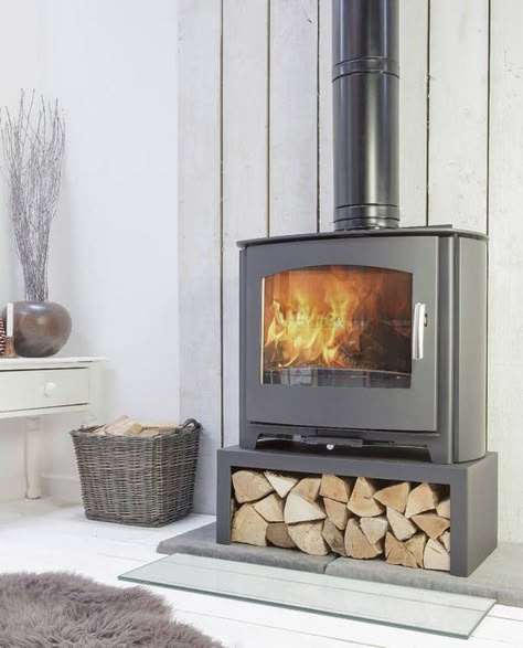 Stove stands and log boxes, stove installation accessories Wood Stove Stand, Wood Burning Stove With Wood Storage, Freestanding Wood Stove Living Rooms, Wood Burning Stove Wall Ideas, Raised Wood Stove, Wood Heater Ideas Living Rooms, Free Standing Log Burner Living Rooms, Corner Log Burner Ideas, Modern Log Burner