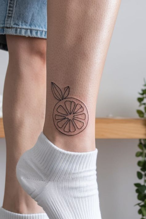 For a minimalist look, a simple outline of a lemon on the ankle offers a chic and understated tattoo. This design is both subtle and modern, making it a cute, easy-to-hide tattoo with lots of personality. Lemon Outline, Hide Tattoo, Lemon Tattoo, Greek God Tattoo, Peace Tattoos, Hidden Tattoos, Hello Kitty Tattoos, Ribbon Tattoos, God Tattoos