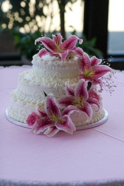 This was our wedding cake. Our colors were inspired by the stargazer lily, my favorite flower. My bouquet and the wedding flowers were stargazers and roses. The church smelled incredible! Wedding Cake With Lilies, Lily Flower Cake, Hibiscus Flower Cake, Stargazer Lily Wedding, Lily Wedding Cake, Wedding Cake With Flowers, Lily Cake, 13 Birthday Cake, Beach Cakes