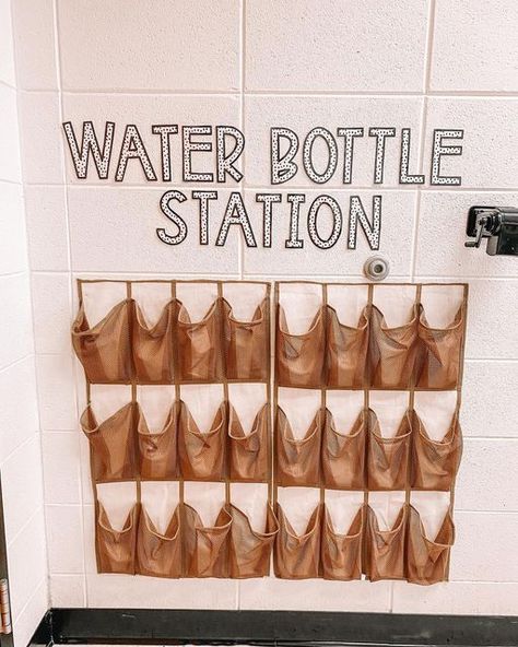 Lauren 👋🏽 LoLo Loves Learning on Instagram: "The Water Bottle Station was upgraded this year! ✨ I added a cute label (made from @missjacobslittlelearbers bulletin board pack on TPT) and cut the shoe organizer in half so all of my first grade students would be able to reach their water bottle! It’s perfect! 🤩" Water Bottle Station, Bottle Station, Classroom Jobs Display, Kindergarten Classroom Setup, Digital Learning Classroom, Water Bottle Organization, Teaching Organization, Water Bottle Storage, We Are Teachers