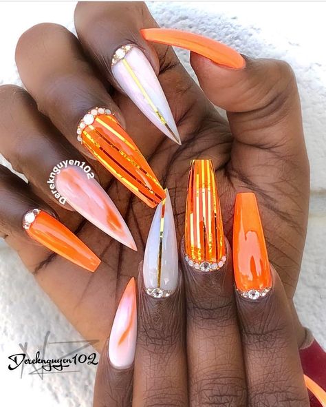 Orange and white coffin nails with stiletto tip Orange White And Gold Nails, Coffin And Stiletto Nails Together, Coffin And Stiletto Nails Mixed, Orange And Silver Nails Prom, Orange Nails Stiletto, Orange And White Nail Designs, Stiletto And Coffin Mix Nails, Fall Stiletto Nails Design, Orange Flame Nail Designs