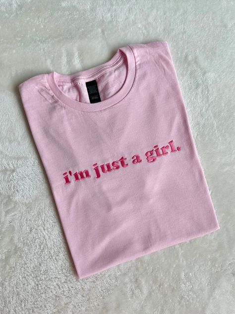 "I'm just a girl!" This super fun and adorable shirt is Handmade with embroidered stitching. Material: 50/50 Cotton, Poly Blend T-shirts are Jersey Knit Soft Fabric Fit: Unisex Ladies should order 1 size down from their normal size for a more snug fit. Care: Machine wash with like colors. Tumble dry like normal. Please be sure to select T-SHIRT or SWEATSHIRT as you will receive the selection you made in the dropdown. Want another color shirt or sweatshirt? Message us before purchasing Self Love Shirt Design, Cute T Shirt Designs, T Shirt Painting Ideas, Cute Pink Shirt, Typography Shirt Design, Embroidered T Shirt, Sweatshirt Girl, I'm Just A Girl, Pink Jersey