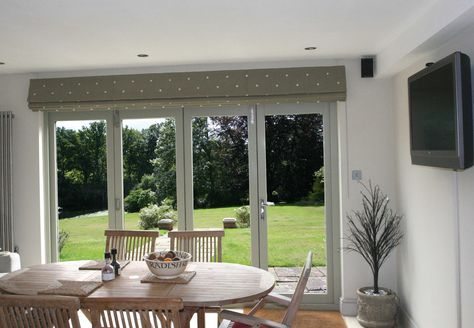 Kitchen with bifold doors with Classic Roman Blind in Moghul embroidered cotton Jinda Spot in Stone. Roman Blinds On Patio Doors, Roman Blinds For Bifold Doors, Blinds Bifold Doors, Dressing Bifold Doors, Roman Blind Patio Doors, Roman Blinds Patio Door, Roman Blinds On Sliding Doors, Roman Blinds Sliding Door, Bifold Doors With Blinds