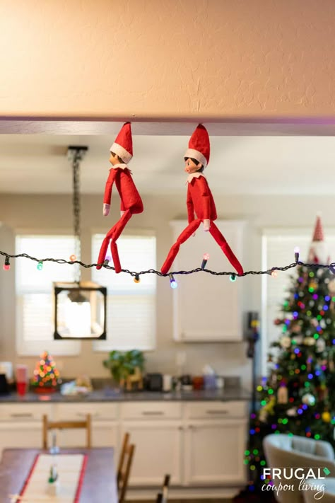 Get ready to take your Elf on the Shelf game to new heights with a whimsical and enchanting idea that will leave your kids wide-eyed and full of wonder. The Elf on the Shelf Tightrope Walker is not only a magical addition to your holiday traditions but also a setup that will have your little ones asking, "How did he do that?" Follow our step-by-step guide to create this festive and gravity-defying scene in your home. New Elf on the Shelf ideas daily plus free Elf on the Shelf printables. Elf On Shelf Ideas With 2 Elves, Elf On The Shelf Riding Dinosaur, Elf In The Shelf Ideas Toddler, Elf On The Shelf Plane Ideas, Parachute Elf On The Shelf, Brother Elf On The Shelf Ideas, Green Elf On The Shelf, Spiderman And Elf On The Shelf, Elf On The Arrival Ideas