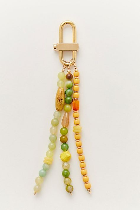 This versatile bag charm is adorned with strands of mixed semi-precious stone beads and a chunky carabiner closure for a chic touch. **Features:** Dangly beaded design, three strands, carabiner closure **Why We ❤ It:** Mix and match for a collected look on your favorite bags. | Prismatic Beaded Bag Charm by Free People in Yellow Beaded Bag, Stone Beads, Semiprecious Stones, Mix And Match, Semi Precious, Free People, Beads, Stone, Yellow