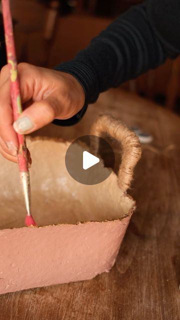 Sibia Torres Padilla | DIYs on Instagram: "We’re still trying to find more uses to paper clay these days.  Yesterday I decided to make a book basket for roses room.   I used three paper bags, soaked them overnight and blended them into a pulp. I use the nut milk bag to squeeze out any extra water and the paper pulp. I added one cup of flour, a pinch of salt and half a bottle of school glue.  Instead of school glue you can use water to turn your flour into a paste.  next, we mixed that up with our hands, and I used a bin as a mold to shape my basket. I let that dry outside for a few hours, and it was ready to decorate I painted it with acrylic paint and added some twine to the handles although I really need to figure out how to fortify the handles a bit more because I don’t know if they wil Paper Clay Projects, Paper Pulp Art, Tiny Doll Clothes, Paper Bag Books, Book Basket, Paper Clay Art, Upcycle Diy, Clay Box, Make A Book