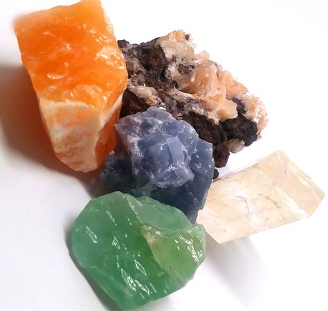 Calcite forms in many different types.  Here, we have Orange Calcite, Blue Calcite, Emerald Calcite, Optical Calcite, and Calcite Crystals in a Matrix.  Most of these types come from Mexico. Optical Calcite, Orange Calcite, Blue Calcite, Calcite Crystal, Crystals Minerals, Minerals Crystals, Crystals And Gemstones, Different Types, Matrix