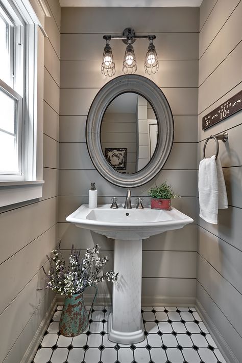 A farmhouse inspired powder room renovation with shiplap walls, pedestal sink, black and white patterned tile, and a rustic mirror and light fixture. Comfy Bathroom, Pedestal Sink Ideas, Pedestal Sink Powder Room, Farmhouse Powder Room, Small Half Bathroom, Powder Room Renovation, Pedestal Sink Bathroom, Walls Design, Powder Room Remodel