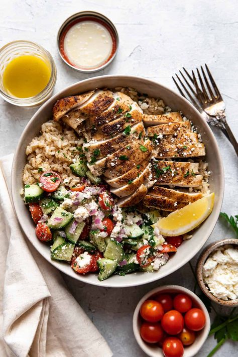 These greek chicken bowls are an easy and healthy summer dinner. Tender greek seasoned chicken and fluffy brown rice are served with an english cucumber salad made up of cherry tomatoes, feta cheese, red onion, parsley and a homemade vinaigrette. Greek Protein Bowl, Greek Bowls Chicken, English Cucumber Salad, English Salad, Best Chicken Tacos, Fluffy Brown Rice, Dinner Greek, Greek Bowl, Cherry Tomatoes Feta