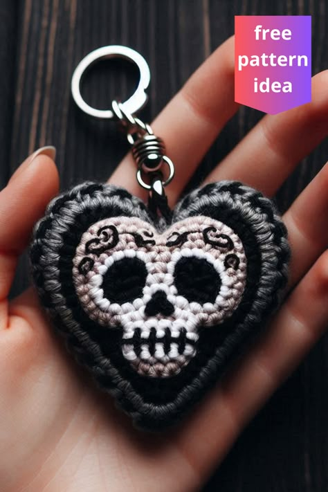 This black crochet skull heart keychain is an edgy, handmade accessory featuring intricate embroidery and a striking skull motif. Crochet Skull Bag Pattern Free, Key Crochet Pattern, Crochet Keychain Holder, Mexican Crochet Ideas, Crochet Ideas For Mom, Crochet Skull Patterns Free, Creepy Crochet Pattern Free, Crochet Key Rings, Skeleton Crochet