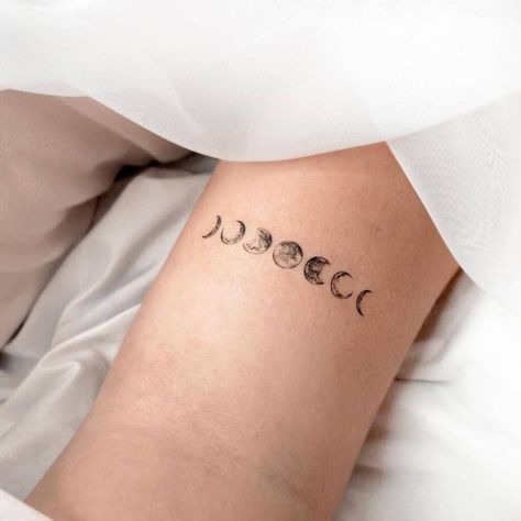 Tiny Moon Phases Tattoo, Moon Phases Tattoo Back Of Neck, Moon Phases Tattoo Line Work, 7 Moons Tattoo, Moon Phases Tattoo Arm Band, Bicep Moon Tattoo, Moon Phase Ear Tattoo, Small Moon Phases Tattoo, Moon Phases Tattoo Thigh