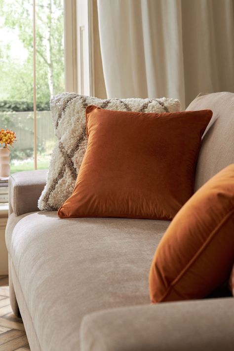 Adding a timeless classic velvet cushion is the perfect way to help dress your sofa or bed. This is a great layering item. Polyester pad included. Dry clean only. 100% Polyester. Burnt Orange Cushions Living Rooms, Rust Cushions Living Rooms, Orange Cushions Living Room, Burnt Orange Cushions, Burnt Orange Pillows Living Rooms, Cream Sofa Cushion Ideas, Cream Sofa Decor, Beige Sofa Cushion Ideas, Sofa Cushions Arrangement