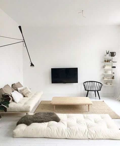 a neutral minimalist living room with off white cushions, wooden furniture, a TV on the wall and a wall lamp Interior Boho, Minimalist Living Room Design, Minimal Interior Design, Decor Ikea, Minimalist Home Interior, Minimalist Interior Design, Minimalism Interior, Decoration Inspiration, Minimalist Home Decor