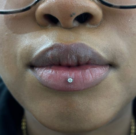 CAN'T STOP, WON'T STOP OBSESSING OVER THIS ASHLEY PIERCING! 😍  ASHLEY PIERCING BY @marcymods TITANIUM PRONG GEM FROM @invictus_bodyjewelry  Soho, Union Square, and Williamsburg  11AM-9PM 7 DAYS A/W🕘 WALK-INZ OR BOOK ONLINE..📕 TATTOOS & PIERCINGS, NO ATTITUDE, NO MISERABLE HOOPS TO JUMP THROUGH....🚫  WALK-INZ WELCOME OR BOOK ONLINE AT  ⚔️livebytheswordtattoo.com⚔️ . . . . #ashleypiercing #lippiercing #bodymod #piercing #soho #manhattan Ashley Piercing Aesthetic, Lip Piercing Black Women, Lip Piercing Ashley, Ashley Piercing Black Women, Ashley Piercing Jewelry, Ashley Lip Piercing, Types Of Lip Piercings, Piercings Facial, Dimple Piercing